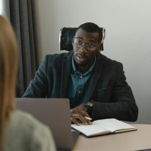 Businessman conducting a formal interview in a modern office environment.