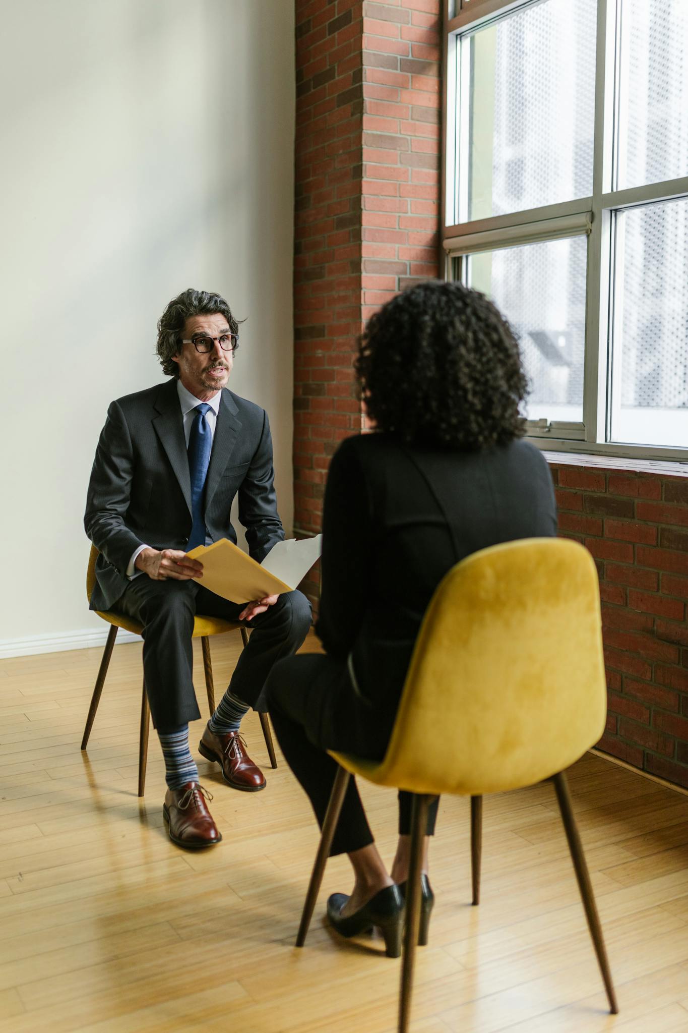 Two professionals in a modern office setting having a conversation. Ideal business and corporate representation.